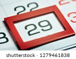 Small photo of twenty-ninth of the month highlighted on the calendar with a red frame close-up macro, mark on the calendar, twenty-ninth date