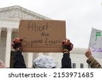 Small photo of Washington, DC â€“ May 08, 2022: A Pro-Choice protester holds a sign calling for the Supreme Court to be aborted in light of the recently leaked draft opinion regarding overturning Roe v. Wade.