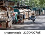 Small photo of Paris, France - October 2, 2023: Parisian Bouquiniste display. Bouquinistes are booksellers of used and antiquarian books, posters and souvenirs, who ply their trade along the banks of the Seine river