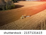 Tractor With Plow On Field...