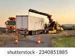 Small photo of Lorry wreck on road. Сar accident on freeway. Recovery Truck Tows a Semi trailer truck after crash. Emergency Rescue Wrecker Tow Truck coach Semi Truck. Towing Vehicle.