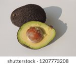 Small photo of Closeup of an avocado cut in two.