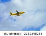 Small photo of MIAMI, FL -13 MAR 2022- View of a yellow airplane in flight from lowcost Spirit Airlines (NK) at the Miami International Airport (MIA), formerly Wilcox Field, a hub for American.