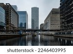 Small photo of London - 01 25 2022: View of Middle Dock at Canary Wharf with skyscrapers and the DLR bridge