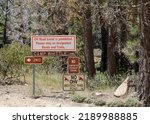 Small photo of Big Bear Lake, California USA - May 21, 2022: The Camp Whittle sign and other information sign at Big Bear Lake in southern California.