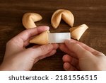 Person taking out blank note with good luck wish from fortune cookie, mockup