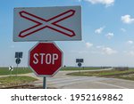 Stop track. Unguarded railway crossing in a rural landscape. 