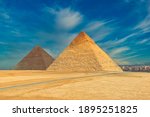 The famous pyramids at Giza in Egypt with a blue sky