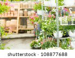 Small photo of Hangup pots with flowers in garden center greenhouse plants shelves