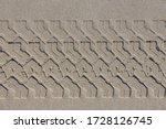 Top view of tire tracks on very fine sand beach, Surface of rubber marks texture, Nature pattern background, Dutch north sea coastline, Netherlands.