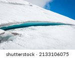 Small photo of Long, gorgeous icy-blue crack or crevasse in glacier