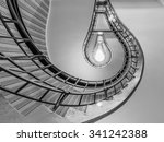Abstract shot of a staircase leading towards a light bulb like opening