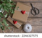 Valentine's Day gift wrapping. Kraft gift boxes decorated with red hearts
