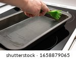greasing baking sheet with oil. Cooking a cake tin