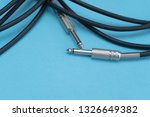 Black audio cable on the blue background