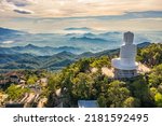 Small photo of Aerial view of Linh Ung Pagoda with a giant buddha statue among green trees and sea clouds floating on the top of Ba Na mountain. Near Golden bridge. Da Nang, Vietnam