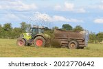 Small photo of York UK August 10 2021 Animal manure and Slurry pit sediment being spread on pasture by a tractor and muck spreader, a natural alternative to inorganic nutrient containing fertilisers.