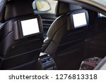Car inside headrest screen mock up. Interior of prestige luxury modern car. Two white displays for back seats passenger with media control panel copy space and place for text.