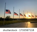 Small photo of Washington, DC / USA - May 15, 2020: Flags at half-mast around the Washington Monument on the National Wall in Washington DC in honor of Peace Officers Memorial Day as part of National Police Week.