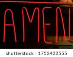 Decorative neon lights, deep red, with the word amen written.