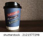 Small photo of Paper coffee cup on copy space background with handwritten text INTROVERT EXTROVERT AMBIVERT, Introvert tend to feel drained after socializing, extrovert tend to feel energized, ambivert in the middle