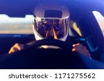 A Helmeted Race Car Driver At...