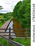 Small photo of Brecon, Powys / Wales,UK-7/16/2020: A view of the Brecon & Monmouthshire Canal on the outskirts of Brecon. The canal towpath means you can walk via the canal to Brecon town centre.