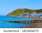 Small photo of Aberystwyth, Ceredigion / Wales UK - 9/19/2020:A view of the seafront buildings of Aberystwyth.Funicular railway takes tourists to the hilltop camera obscura. Boys playing on beach landing stage.