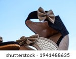 Stock photo of beautiful pair of black and cream color high heel sandals displayed on blur background,kept on table under bright sunlight at Bangalore city Karnataka India.