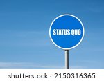 Small photo of 'Status quo' sign in blue round frame. Clear sky is on background
