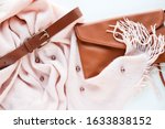 Women's fashion and style. women's accessories. warm pink scarf, women's belt and handbag. flat lay