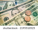 United States dollar bills with a few cent coins. Closeup photography. Finance and Economy concepts.
