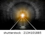 A look into a station tunnel. Fast underground train riding in a tunnel. Subway, underground, crossing in the tunnel, with front lighting