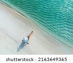 Holidays in the Maldives. Paradise tropical beach. Woman on the background of the sea and sunny beach. Travel, tourism and relaxation