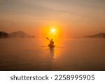 Women on kayak rows in the reservoir during the sunrise, Harirak forest park Huai Nam Man reservoir Loei Thailand