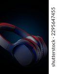 Small photo of black headphone taken in soft focus, over-ear wireless audio equipment with noise canceling ear pads or ear cushions isolated dark background with dramatic lighting and copy space