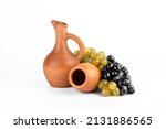 Georgian traditional clay vessel kvevri (qvevri ), jug(doqi)  for wine and grapes on white isolated background.