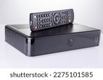 TV set-top box prepared for installation, digital TV kit on white background close-up with reflection. High quality photo