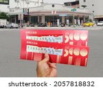 Small photo of Kaohsiung, Taiwan, October 8, 2021: Five stimulus coupons. Taiwan issues stimulus coupons to boost the economy. Holding five stimulus coupons