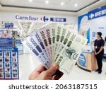 Small photo of Kaohsiung, Taiwan, October 8, 2021: Five stimulus coupons. Taiwan issues stimulus coupons to boost the economy. Holding five stimulus coupons, the background is deliberately blurred