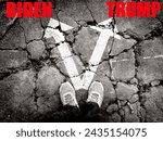 A pair of feet standing on cracked asphalt (repeated exposure) with arrow prints pointing in two different directions, concept of the 2024 US presidential election. Trump vs. President Biden.