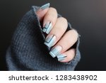 negative space manicure  of gray nail polish with black and white stripes design