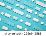 Small photo of Pads of chewing gum on blue background. Fresh mint bubble gum. Top view