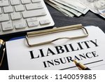 Liability insurance agreement on the desk.