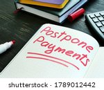 Small photo of Postpone payments red memo on the page and calculator. Deferment or Forbearance concept.