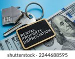 Small photo of Key, cash and plate with sign Rental property depreciation.