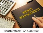 Book with money management on a table.