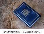 Small photo of Hebrew Bible with raindrops on wet vintage background. Hebrew Bible is pronounced in Hebrew as an abbreviation of the Tanach from the words - Torah, Neviim, Ketuvim (title of the book, translation)