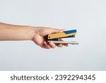 Small photo of stapler, view side stapler with hand pressed on white background.
