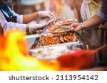 Small photo of Chef Cater cooking main dish crab and shrimps BBQ serving for guest in wedding ceremony party or outdoor seafood gardens. Buffet or fine dining event. Food Festival cooking catering celebrates ideas.